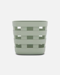 a small green basket sitting on top of a table