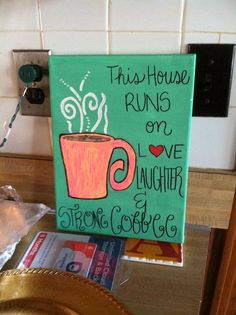 this house runs on love, laughter and strong coffee painted on canvas in the kitchen