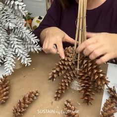 a woman is making pine cones out of sticks