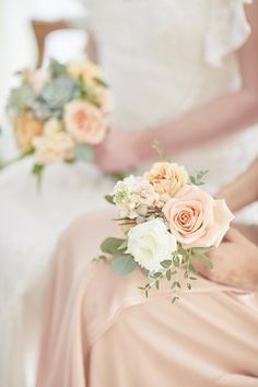 two bridesmaids are holding bouquets in their hands