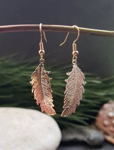 Gold Feather Earrings. Handmade using alloy metal filigree etched feather shaped pendants placed on stainless steel golden coloured hook back ear wire or round golden round lever back Earrings, please chose in options before checkout. The feather pendants are 3.5 cm in length and 1.5 cm in width.  These beautiful boho golden feather Earrings are a perfect gift for her, mum, daughter, girlfriend, wife and every day accessory. The feather pendants have a detailed design and wonderful spiritual ang Adjustable Gold Feather Earrings, Gold Feather Earrings As A Gift, Gold Feather Earrings For Gift, Dangle Feather Jewelry As A Gift, Feathered Dangle Jewelry As A Gift, Earrings With Price, Gold Feather Earrings, Gold Feathers, Spring Jewelry