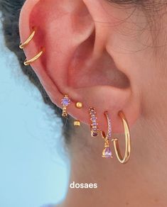 a close up of a person's ear with three different types of piercings