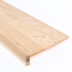 a piece of wood sitting on top of a white surface