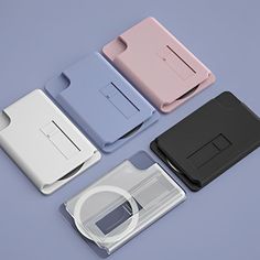 four different types of electronic devices sitting on top of each other, all in different colors