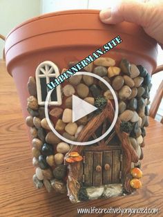 a clay pot with rocks in it and a video playing