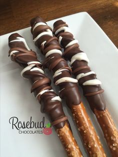 chocolate covered pretzels are lined up on a white plate with the words rosebud chocolates