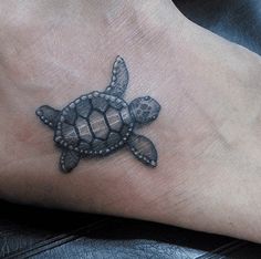 a small turtle tattoo on the foot