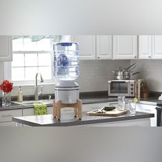 a water cooler sitting on top of a kitchen counter