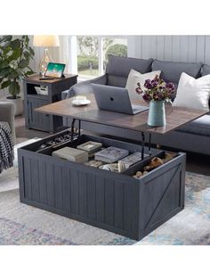 a living room filled with furniture and a laptop computer on top of a coffee table