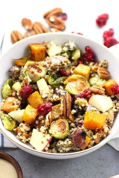 a white bowl filled with vegetables and nuts