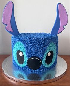 a cake with blue frosting and purple icing