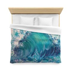 a bed with an ocean themed comforter and pillows