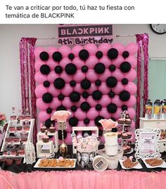 a pink and black themed birthday party with balloons, desserts, and snacks on the table