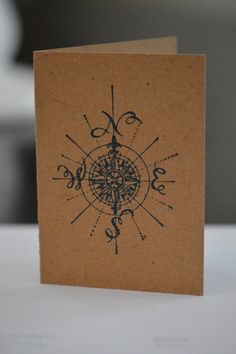 a brown card with an image of a compass on it