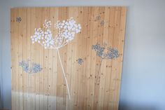 a wooden paneled wall with flowers painted on it