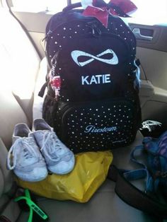 a backpack and pair of shoes in the back seat of a car