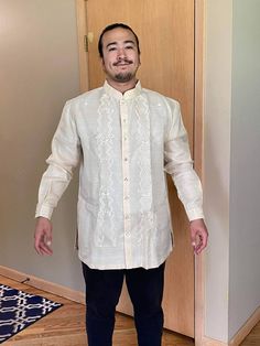 "Classic but modern barong Tagalog. It is made of pinya jusi embroidered fabric. Available and ships from New York, USA. Piña Jusi Fabric-These hand-embroidered fabric is made out of Piña, an intricately hand-woven fabric from pineapple husks and also woven with Cocoon or Silk or Jusilyn. This fabric is  commonly use to make \"barongs\" - a formal wear in the Philippines. Famous fabric from Lumban, Laguna Philippines. Embroidery design is fern-like floral, natural ivory color, very classic and t Traditional Wear With Floral Embroidery For Ceremony, Long Sleeve Traditional Wear With Tonal Embroidery For Wedding, Traditional Long Sleeve Wear For Ceremony, Festive Wedding Kurta With Tonal Embroidery, Festive Traditional Wear With Tonal Embroidery For Wedding, Traditional White Kurta For Ceremony, Festive Traditional Wear With Tonal Embroidery, Long Sleeve Traditional Wear With Pallu For Ceremonies, Fitted Traditional Kurta With Tonal Embroidery