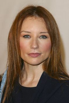 a woman with brown hair and blue eyes