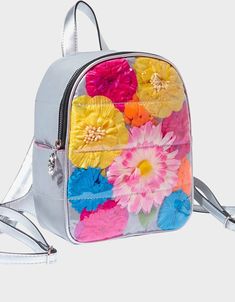 Betsey Johnson, Not Your Garden Variety Mini Backpack Floral Print  This sleek mini backpack has a smooth metallic silver surface decorated with a bright collection of large colorful flowers. Backpack Flower print Silver hardware Adjustable straps Adjustable drop strap Top handle Side pocket Silver exterior w front large colorful floral print 10" H x 9" W x 4" D Spring Standard Backpack With Adjustable Strap, Multicolor Standard Backpack For Spring, Everyday Spring Rectangular Backpack, Spring Backpack With Zipper Closure, Lips Logo, Velvet Backpack, Small Luggage, Design Backpack, Kiss Lips