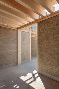 an empty room with brick walls and wooden beams