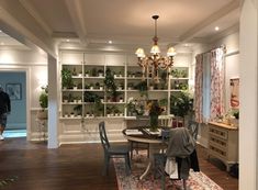 a dining room with lots of plants on the shelves