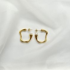 Pearl Hoop Earrings14K Gold Plated Stainless SteelOur Pearl Hoops are the perfect marriage of elegance and charm and will make a delightful addition to any jewelry collection. This lightweight accessory is minimalist in make, yet timeless in style. The unique pair is made with 14K Gold Plated Stainless Steel allowing its color to remain over time. It is accented with pearl impression.All of our products are lightweight and made with hypoallergenic materials to allow for comfortable, all day wear Elegant Gold Hoop Earrings In Recycled Gold, Classic Small Hoop Earrings In Recycled Gold, Elegant Recycled Gold Huggie Earrings Tarnish Resistant, Minimalist Gold Huggie Earrings For Wedding, Timeless Gold Hoop Earrings For Wedding, Minimalist Single Yellow Gold Pearl Earring, Elegant Recycled Gold Huggie Earrings, Minimalist Gold Plated Hoop Earrings For Formal Events, Minimalist Tarnish-resistant Hoop Earrings For Wedding