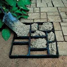 there is a square tray with gravel in it on the ground