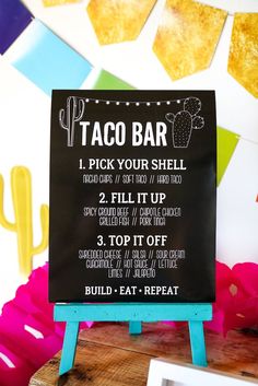 a sign that says taco bar on it next to some other things in the background