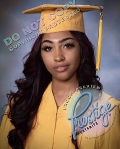 a woman wearing a yellow graduation cap and gown with long hair in front of a gray background