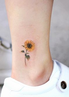 a small sunflower tattoo on the ankle is one of the most beautiful tattoos i've ever seen