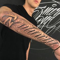 a man with a tattoo on his arm that reads'welcome home'in cursive writing