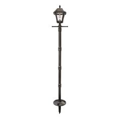 an outdoor lamp post with a light on it's top and two lights attached to the pole