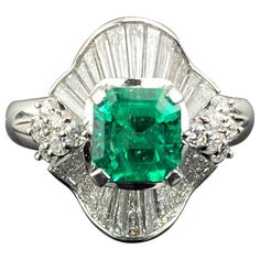 A classic, art-deco 1.18 carat Colombian Emerald and 1.34 carat Diamond baguette ring, set in platinum. The center stone has an ideal vivid green color, and a great shine/luster to it. The Emerald is transparent, and is of a very high quality. The ring is currently sized at US6, can be resized. Please feel free to message us for more information. We provide free shipping, and accept returns. Emerald Green Jewelry, Emerald Diamond Engagement Ring, Emerald Ring Engagement Diamond, Stunning Diamond Rings, Contemporary Engagement Rings, Green Emerald Ring, Platinum Diamond Engagement Rings, Baguette Diamond Rings, Emerald Diamond Ring