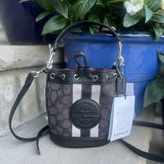 Brand New With Tags. Color: Black/Smoke Black Signature Jacquard And Refined Pebble Leather One Credit Card Slot Drawstring Closure, Fabric Lining Detachable Handle With 5 1/2" Drop Detachable Strap With 23" Drop For Shoulder Or Crossbody Wear 5 1/2" (L) X 6 1/2" (H) X 3 1/2" (W) This Coach Piece Is Crafted Of Our Signature Jacquard Made From A Blend Of Organic Cotton And Recycled Polyester Msrp 278.00 Luxury Black Bucket Bag With Leather Trim, Black Coated Canvas Bucket Bag, Black Coated Canvas Bucket Shoulder Bag, Black Leather Trim Bucket Bag For Travel, Coach Black Bucket Bag With Removable Pouch, Black Leather Trim Bucket Bag, Black Bucket Bag With Branded Hardware For Travel, Black Travel Bucket Bag With Branded Hardware, Pebbled Leather