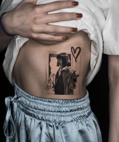 a woman's stomach with a black and white photo on the back of her belly