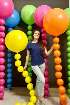 a woman is posing in front of balloons