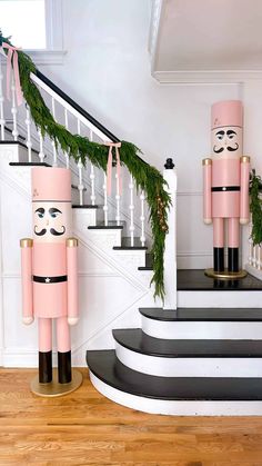 two pink nutcrackers are standing on the stairs