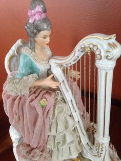 a statue of a woman playing a harp