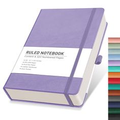 a purple colored notebook next to a stack of multicolored paper sheets with the words,'rolled notebook'written on it