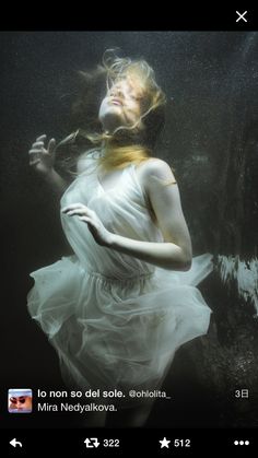 a woman in a white dress under water