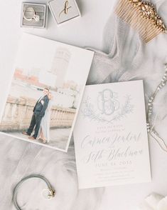 an image of a wedding set up with rings and jewelry on the bed next to it