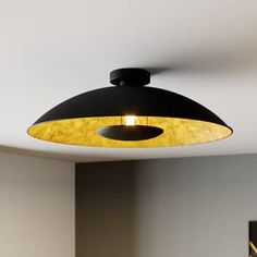 a black and gold light fixture in a room