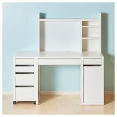 a white desk with two drawers and a bookcase on it in front of a blue wall