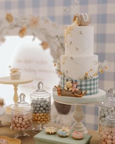 a table topped with lots of cakes and candies