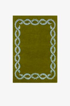 a green area rug with an ornate border