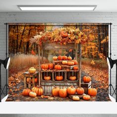 an image of pumpkins on display in front of a brick wall with fall foliage