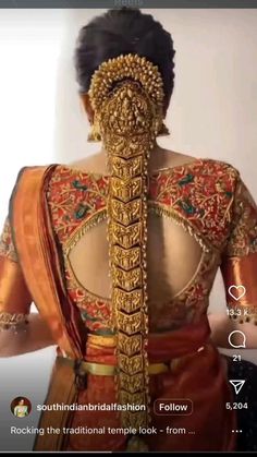 the back of a woman's blouse is adorned with gold jewelry