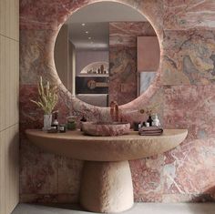 a bathroom with a round mirror on the wall and marble counter top in front of it