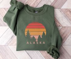 This Alaska sweatshirt is great for the Alaska lovers out there!  Also a fun shirt to wear on your upcoming Alaska cruise.  This unisex, heavy blend crewneck sweatshirt is pure comfort and will quickly become your go-to.     COLOR: This Gildan 18000 sweatshirt comes in several colors, look at the drop down for options.   SIZING: These sweatshirts are UNISEX in size.  Please check the size chart in listing photos for best fit!   MATERIAL:  -Made from polyester and cotton with a ribbed knit collar Mountain Shirt, Christian Sweatshirt, Faith Shirt, Sedona Arizona, Gildan Sweatshirts, Cozy Sweatshirts, Look Plus, Christian Shirts, Sedona