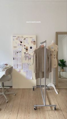 an image of a clothes rack in the middle of a room with clothing on it